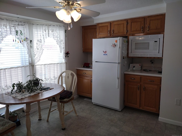 kitchen featuring brown cabinetry, white appliances, light countertops, and ornamental molding