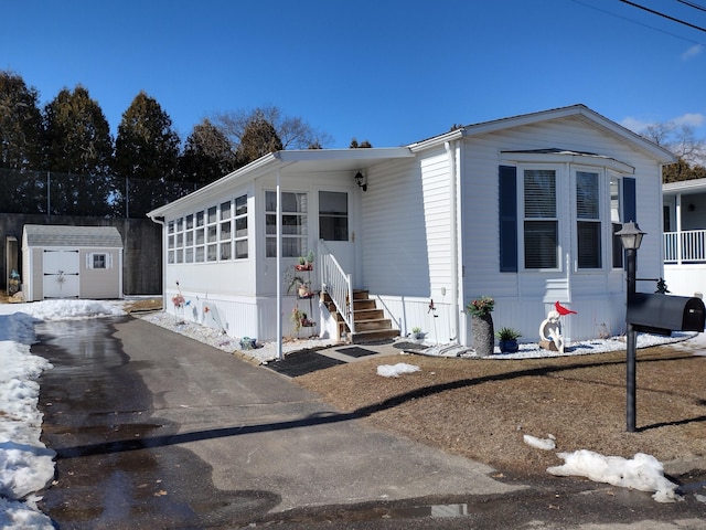 manufactured / mobile home featuring an outbuilding and a storage unit