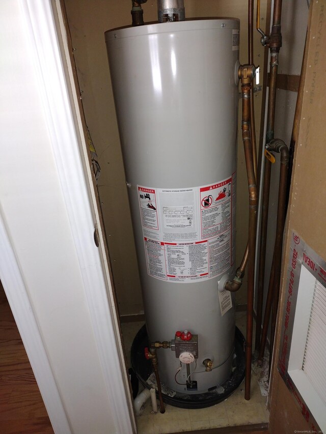 utility room featuring gas water heater