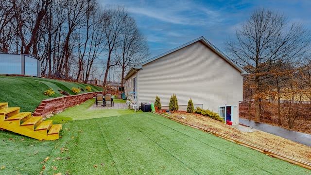 view of side of property with a yard and a patio