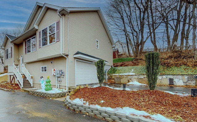 view of home's exterior with a garage and driveway