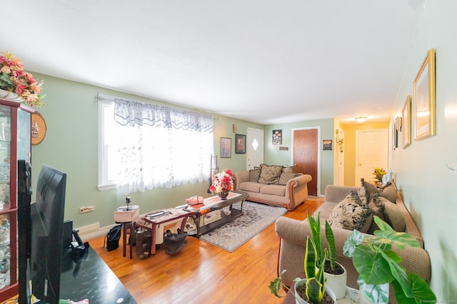 living room featuring baseboards and wood finished floors