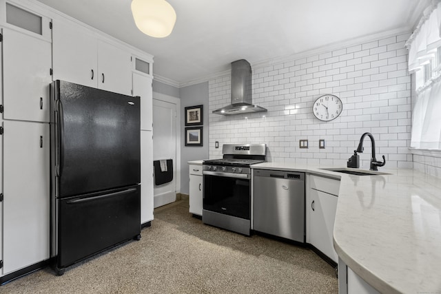 kitchen with stainless steel appliances, a sink, white cabinets, wall chimney range hood, and decorative backsplash