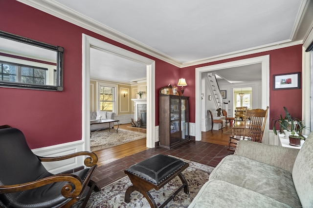 living area featuring a fireplace and ornamental molding