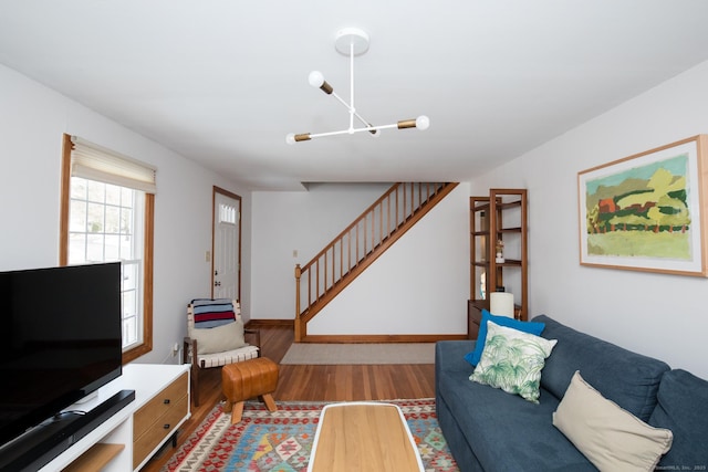 living area with wood finished floors and stairs