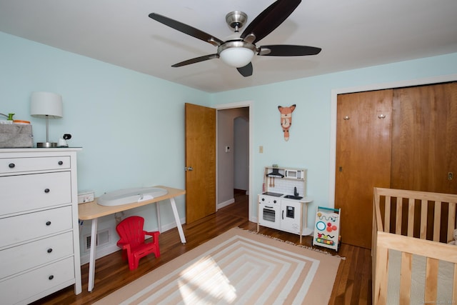 bedroom featuring a ceiling fan, wood finished floors, visible vents, and baseboards