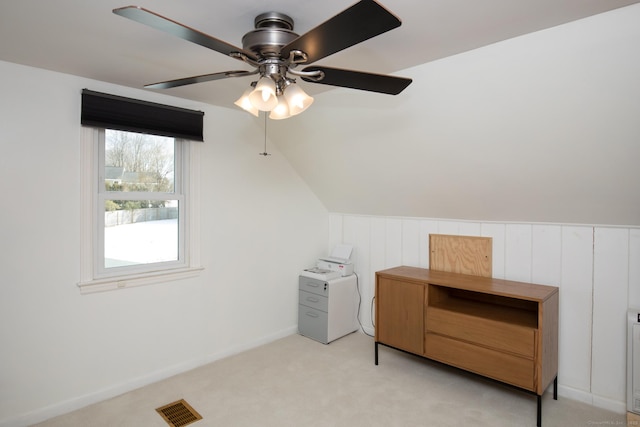 additional living space with lofted ceiling, ceiling fan, light colored carpet, visible vents, and baseboards