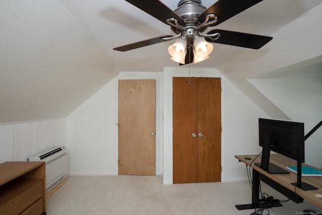 home office with lofted ceiling, ceiling fan, and light colored carpet