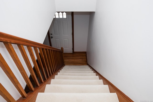 staircase featuring wood finished floors