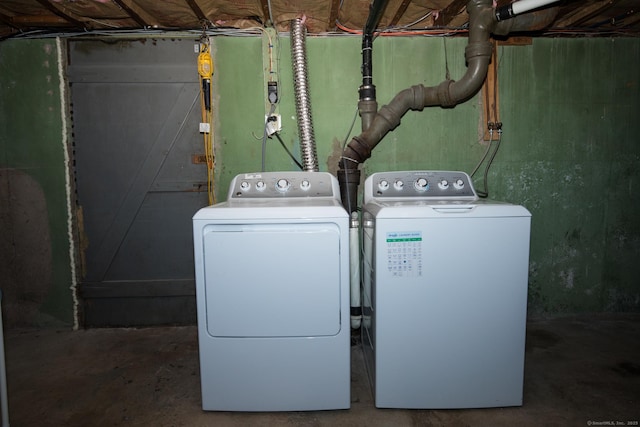 clothes washing area featuring washing machine and dryer and laundry area