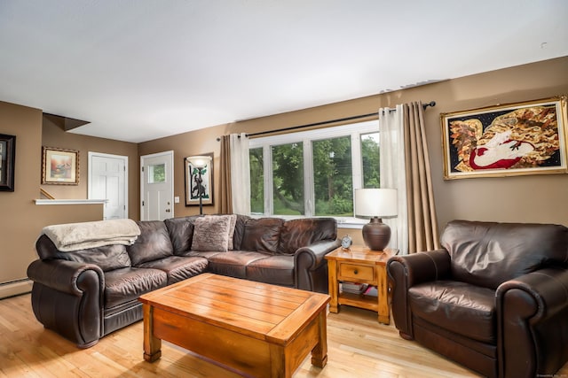 living room featuring light wood-style floors and a baseboard heating unit