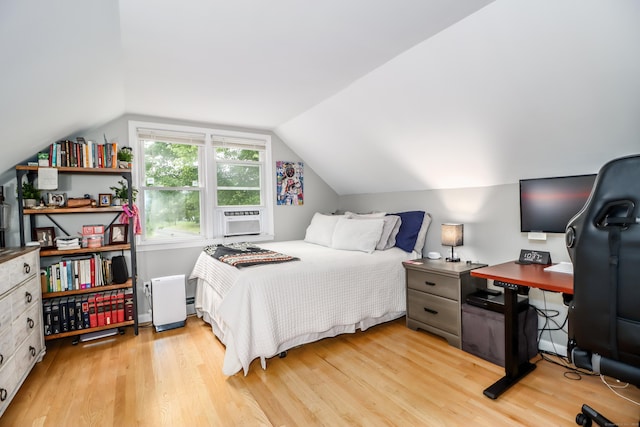 bedroom with light wood finished floors, vaulted ceiling, and cooling unit