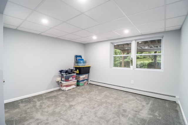 recreation room with a baseboard heating unit, carpet, a paneled ceiling, and baseboards