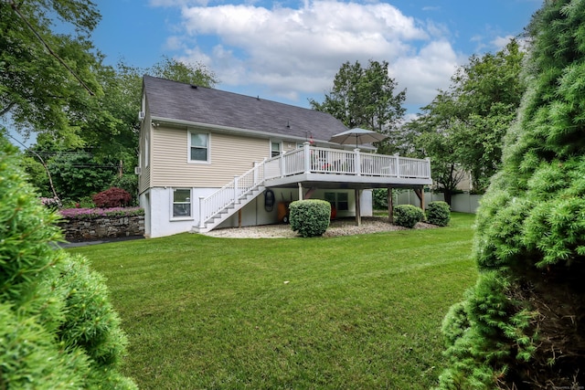 back of property featuring a yard, a deck, and stairs