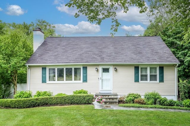 view of front of property featuring a front yard and a chimney