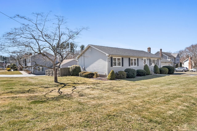 view of front of house featuring a front lawn and a chimney