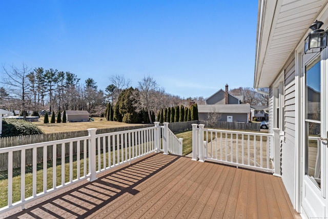 wooden terrace featuring fence