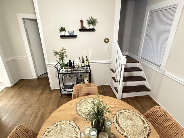 dining area featuring stairs and wood finished floors