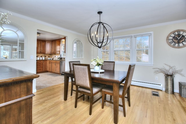 dining space with a baseboard heating unit, light wood-type flooring, visible vents, and crown molding