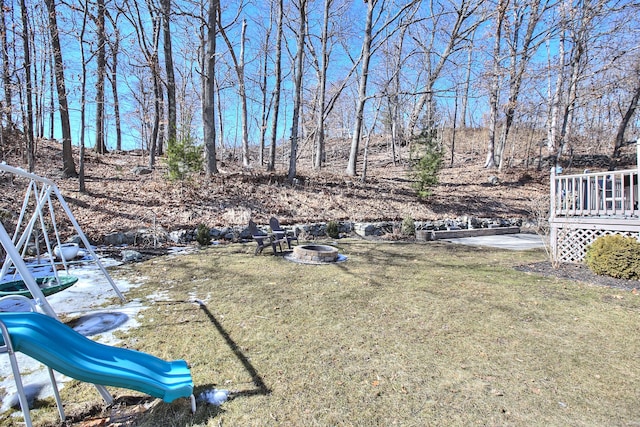 view of yard with an outdoor fire pit and a wooden deck