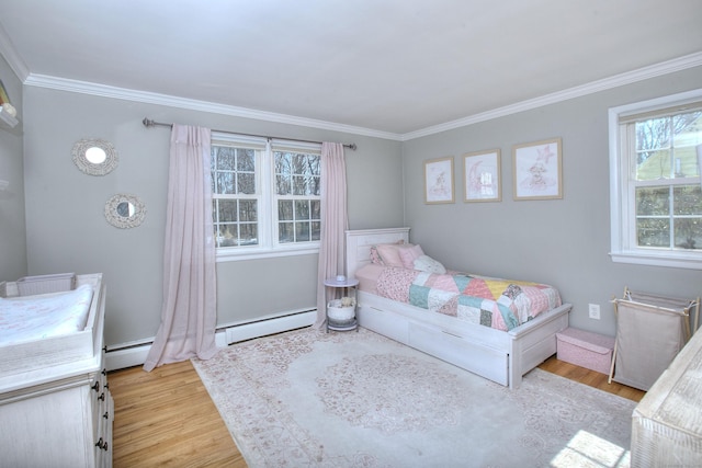 bedroom with a baseboard heating unit, crown molding, light wood-style flooring, and baseboard heating