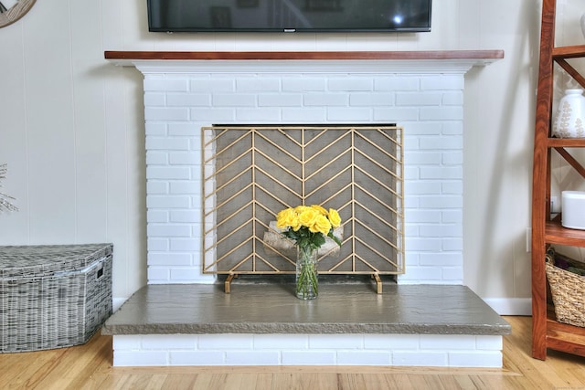 interior details featuring a fireplace and wood finished floors