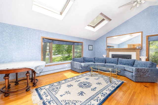 30 Holly Cir, Windsor, CT 06095 - living room featuring a skylight, wood finished floors, ceiling fan, a fireplace, and high vaulted ceiling