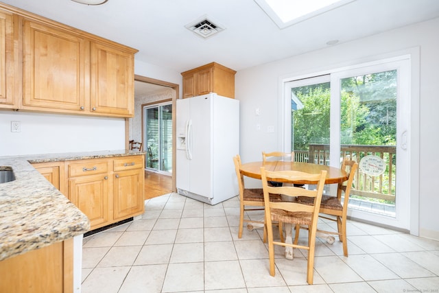 30 Holly Cir, Windsor, CT 06095 - kitchen with white refrigerator with ice dispenser, light stone countertops, light tile patterned flooring, and light brown cabinetry