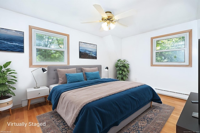 30 Holly Cir, Windsor, CT 06095 - bedroom featuring baseboard heating, multiple windows, light wood-style flooring, and a ceiling fan