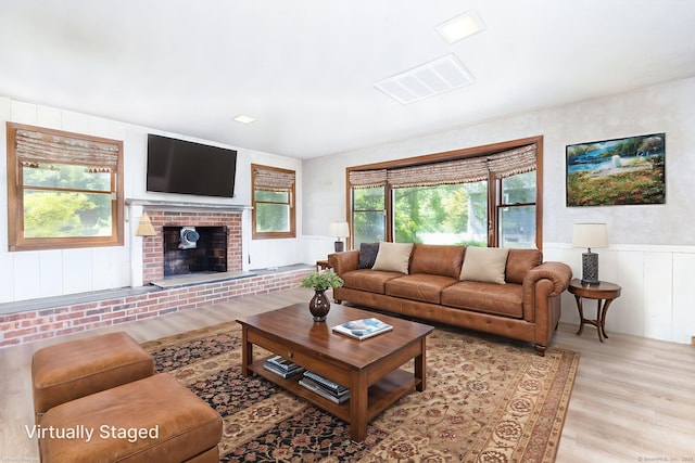 30 Holly Cir, Windsor, CT 06095 - living room with light wood-type flooring, a fireplace, and wainscoting