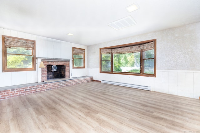 30 Holly Cir, Windsor, CT 06095 - unfurnished living room featuring a baseboard heating unit, wood finished floors, plenty of natural light, and wainscoting