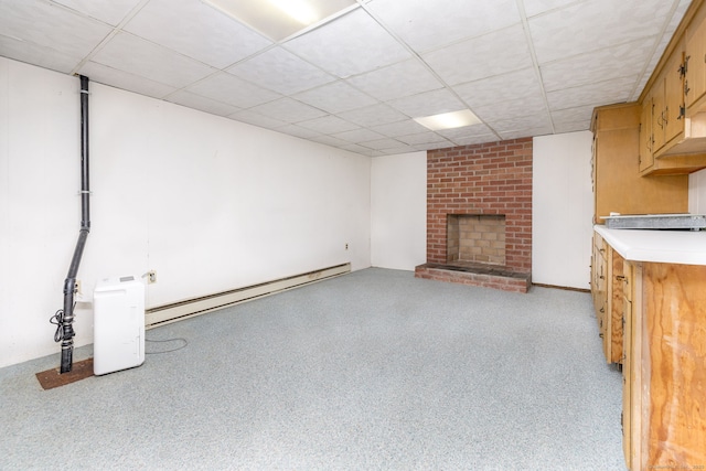30 Holly Cir, Windsor, CT 06095 - unfurnished living room featuring a baseboard radiator, a paneled ceiling, and a brick fireplace