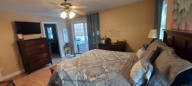 bedroom with ceiling fan, light wood finished floors, baseboards, and access to exterior