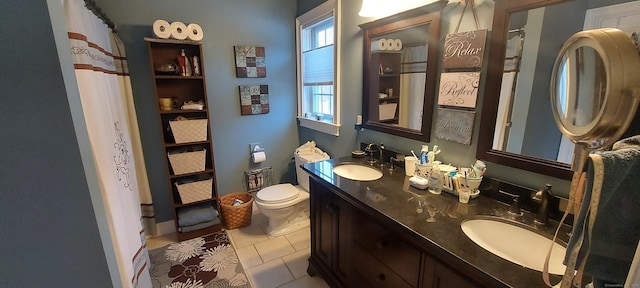 bathroom featuring tile patterned flooring, a sink, toilet, and double vanity