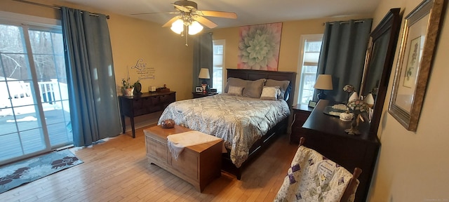 bedroom with access to outside, ceiling fan, and light wood finished floors