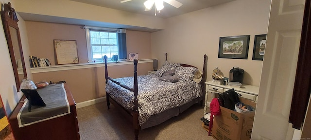 bedroom with a ceiling fan, baseboards, and carpet flooring