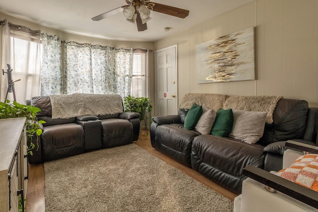 living area with ceiling fan and wood finished floors