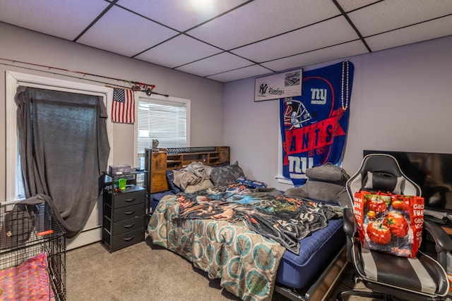 carpeted bedroom with a paneled ceiling