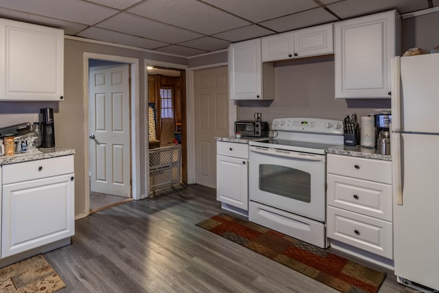 kitchen featuring white cabinets, white appliances, dark wood finished floors, and a drop ceiling