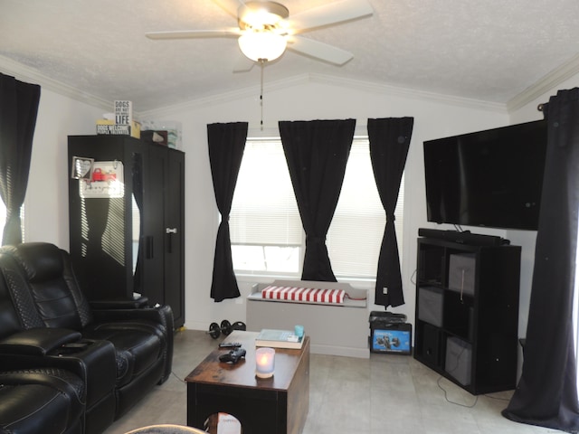 living room with a textured ceiling, ornamental molding, vaulted ceiling, and a ceiling fan