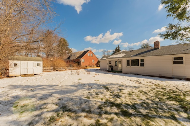 view of yard featuring a storage shed and an outbuilding