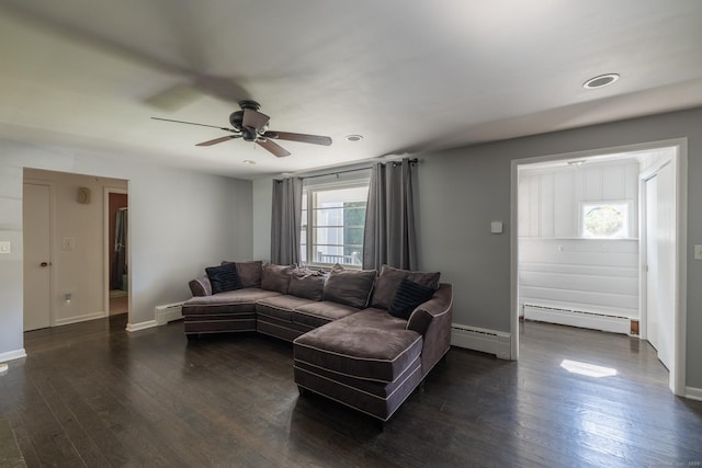 living room with dark wood-type flooring, baseboards, and baseboard heating