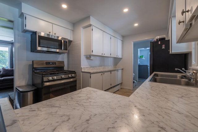 kitchen featuring appliances with stainless steel finishes, recessed lighting, a sink, and white cabinets