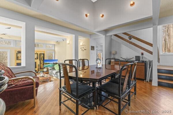 dining space with stairs and wood finished floors