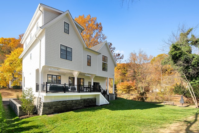 back of house featuring covered porch and a lawn