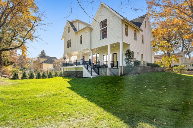 back of house with stairway and a yard