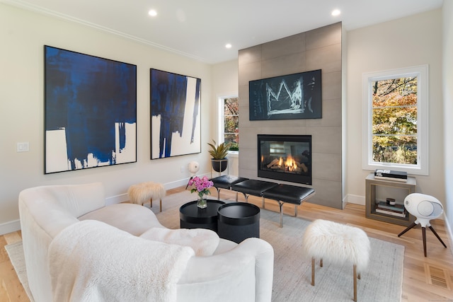 living area featuring recessed lighting, baseboards, and a tile fireplace