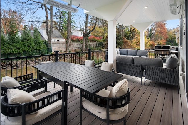 wooden deck with fence, outdoor lounge area, and outdoor dining space