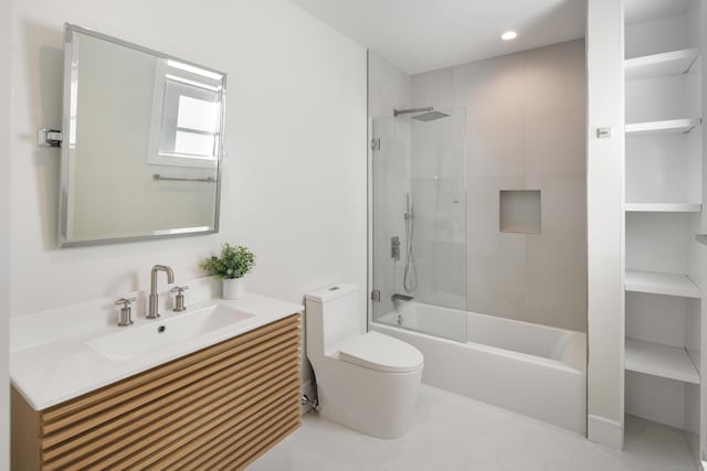 bathroom featuring washtub / shower combination, vanity, and toilet