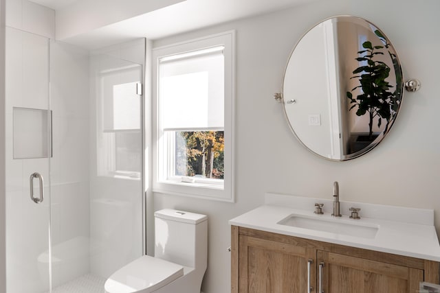 full bath with a stall shower, vanity, and toilet